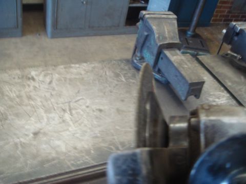 1996 Ford Bronco - A close-up view of a grinding wheel and a metal vise, suggesting a workshop or repair setting.