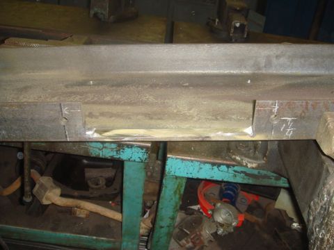 1996 Ford Bronco - Close-up of a metal frame section with a drilled hole and a measurement marked as '1/4'.