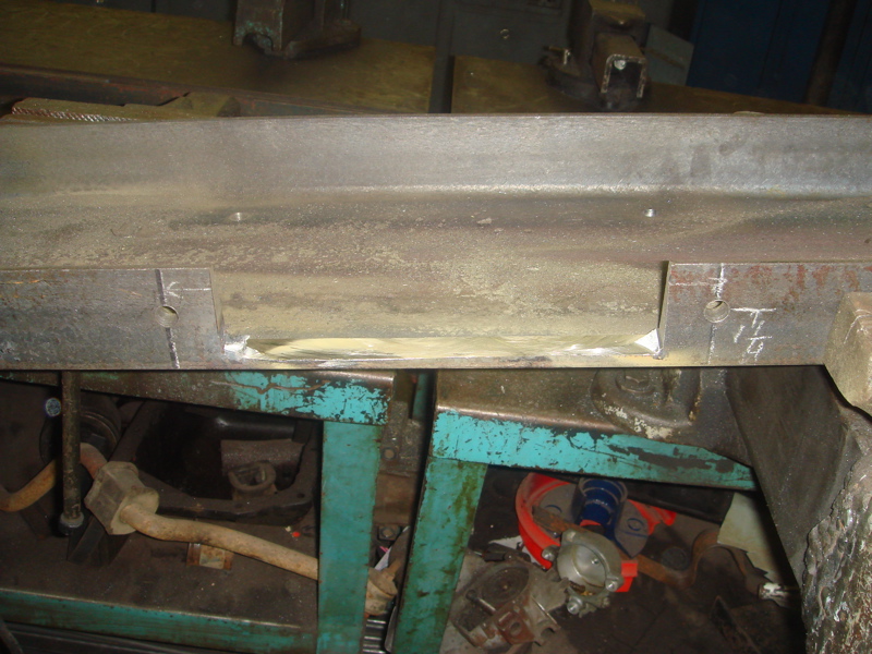 Metal frame with '1/4' marking and hole drilled