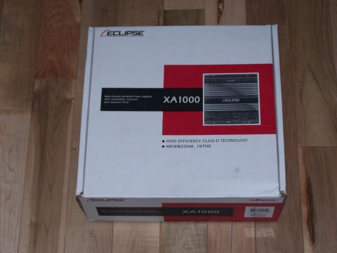 1995 Ford Probe - The box for an Eclipse XA1000 amplifier is shown on a wooden floor.