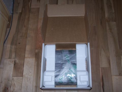 1995 Ford Probe - A car stereo is shown inside its shipping box, protected by foam inserts.