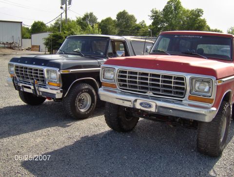 1978 Ford Bronco - 1978 Ford Bronco and another Ford Bronco parked outdoors on a gravel lot.