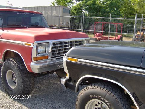 1978 Ford Bronco - Front view of a red 1978 Ford Bronco parked next to another truck.