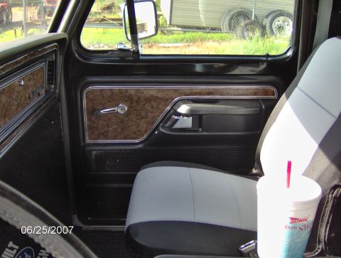 1978 Ford Bronco - Interior view of a 1978 Ford Bronco, woodgrain trim and a two-tone seat.