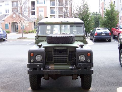 1974 Land Rover Land Rover - Olive green 1974 Land Rover Defender parked in a lot with other vehicles.