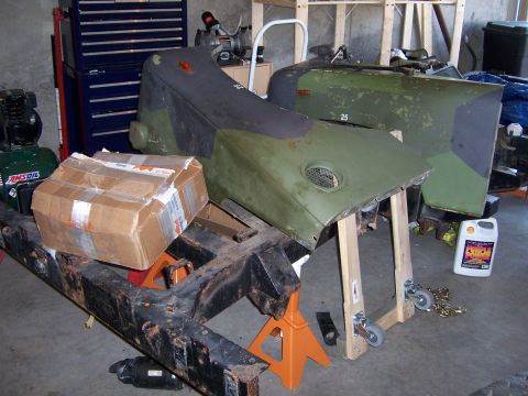 1974 Land Rover Land Rover - Land Rover Series III chassis and body panels undergoing restoration in a garage.