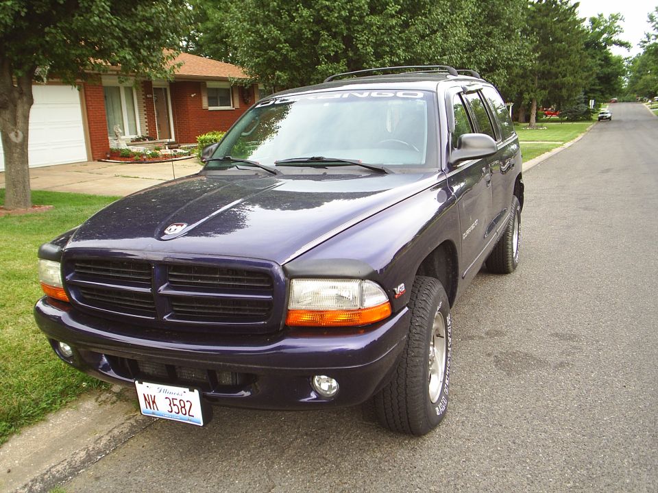 Dark purple Dodge Durango SUV parked on a residential street