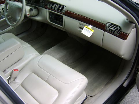 1996 Mercury Grand Marquis - Interior view of a car with a warning tag attached to the glove compartment door.