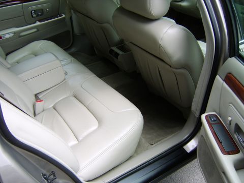 1996 Mercury Grand Marquis - The interior of a car shows tan leather seats and door panels.