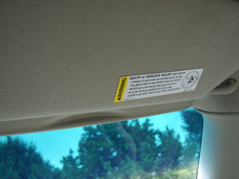 1996 Mercury Grand Marquis - Interior view of a sun visor with an air bag warning label attached.