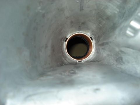 1999 Ford Crown Victoria - View looking down inside a cast aluminum transmission extension housing at the copper-colored bronze bushing pressed into the tail bore, wi…