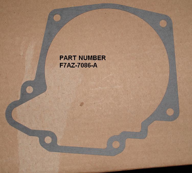 Gray transmission extension housing gasket on cardboard labeled part number F7AZ-7086-A