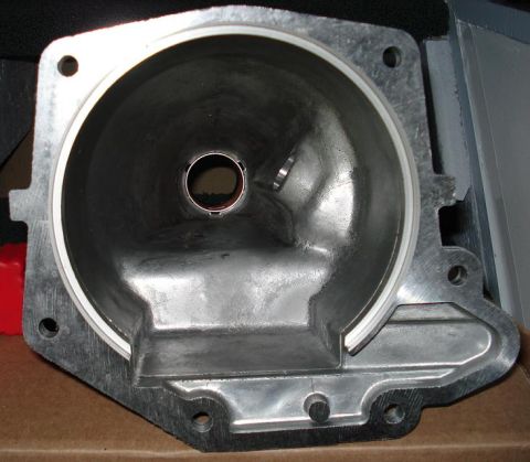 1999 Ford Crown Victoria - Looking straight into the open mounting flange of an aluminum transmission extension housing, showing the machined sealing face with white…