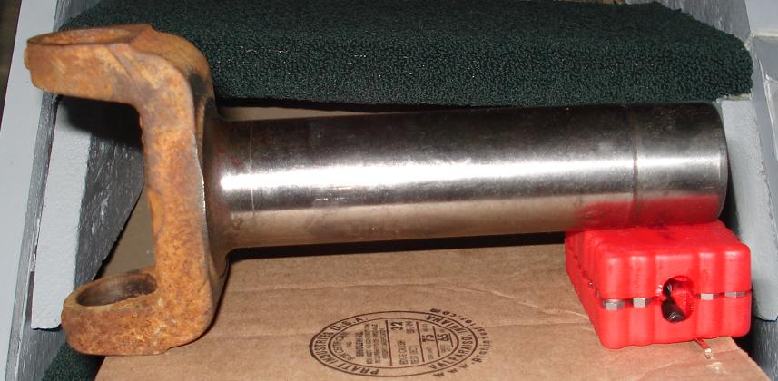 Side view of driveshaft slip yoke with polished shank and rusty U-joint ears