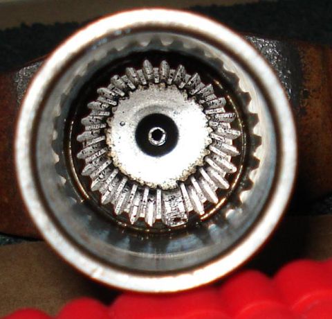 1999 Ford Crown Victoria - Extreme close-up down the bore of a driveshaft slip yoke, showing the machined internal splines and the polished outer sealing surface of t…
