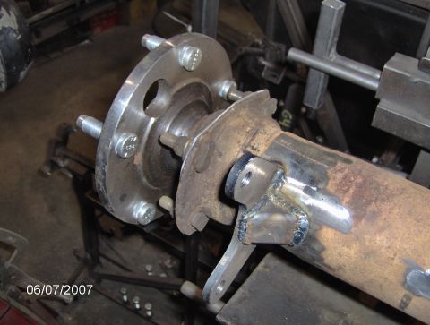 1978 Ford Bronco - Rear axle assembly with brake rotor and hub, likely undergoing modification or repair.