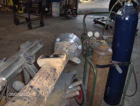 1978 Ford Bronco - Rear axle assembly with welding equipment and gas cylinders in a workshop setting.