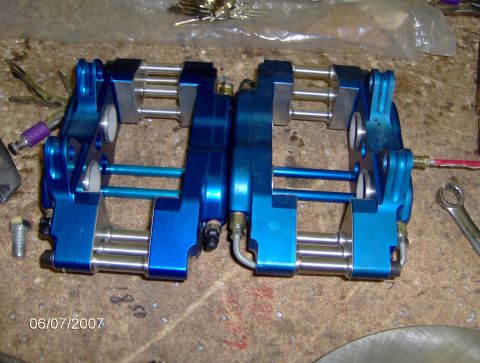 1978 Ford Bronco - Pair of blue brake calipers with silver pistons and lines on a workbench, dated 06/07/2007.