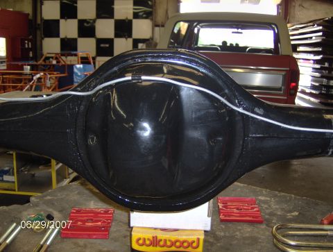 1978 Ford Bronco - A rear differential assembly is shown in a workshop setting with a vehicle in the background.