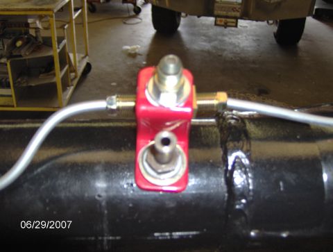 1978 Ford Bronco - Close-up of a brake line fitting on a vehicle's rear axle.