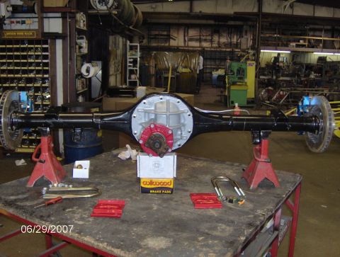 1978 Ford Bronco - A rear axle assembly, likely for a custom build, is displayed on jack stands in a workshop setting.