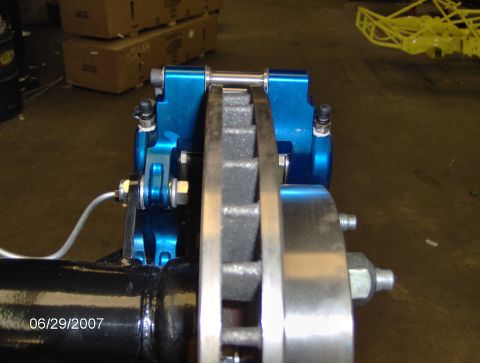 1978 Ford Bronco - A close-up view of a rear disc brake assembly, showing the caliper and rotor mounted on the axle.