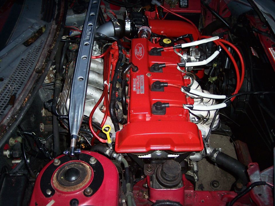 1994 Ford Probe engine bay with red valve cover and Ford logo