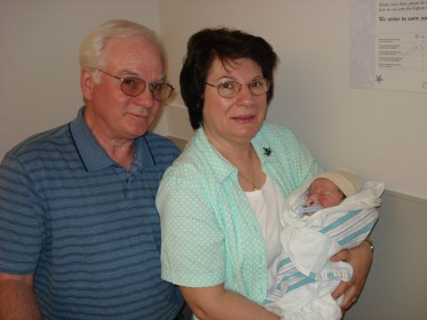2000 Ford Crown Victoria - Grandparents proudly hold their newborn baby.