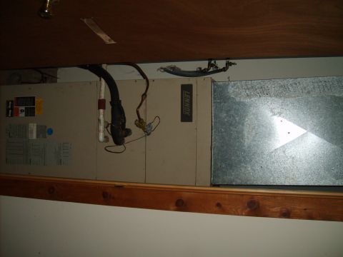 2004 Ford Crown Victoria - The photo shows an HVAC unit with associated plumbing and ductwork, mounted above a wooden shelf.