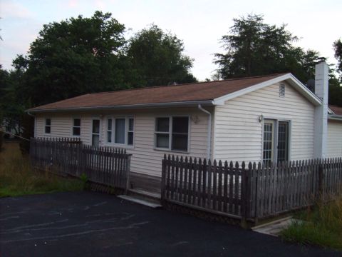 2004 Ford Crown Victoria - Exterior view of a single-story house with a deck and fence.