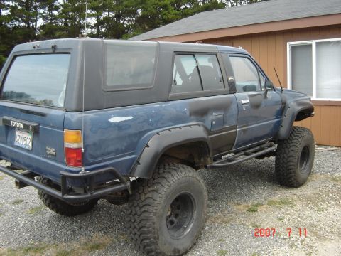 1993 Ford Bronco - This modified blue Toyota 4Runner features a lifted suspension and large off-road tires, suggesting it's built for terrain.