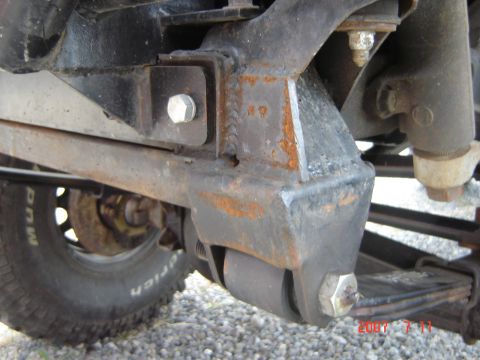 1993 Ford Bronco - This image shows the undercarriage of a vehicle, focusing on the suspension system and tire.