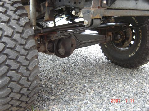 1993 Ford Bronco - Close-up view of the rear axle and suspension system of an off-road vehicle.