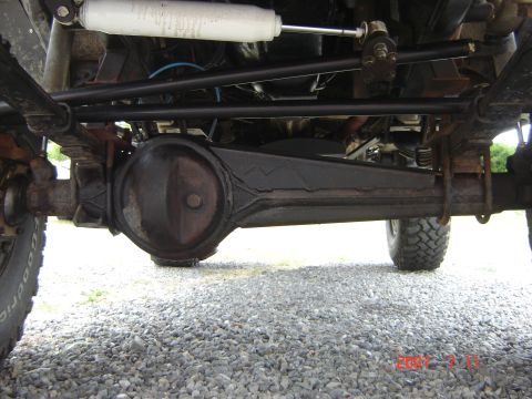 1993 Ford Bronco - A close-up view of the undercarriage reveals the vehicle's suspension system and differential.