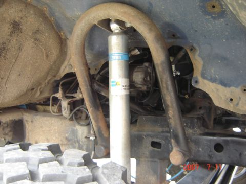 1993 Ford Bronco - Close-up view of the rear suspension system, a Bilstein shock absorber and a large off-road tire.