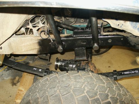 1993 Ford Bronco - Undercarriage view shows suspension components and a tire, with some text visible on the leaf spring.