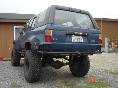 1993 Ford Bronco - This modified blue Toyota 4Runner features oversized off-road tires and a custom rear bumper.