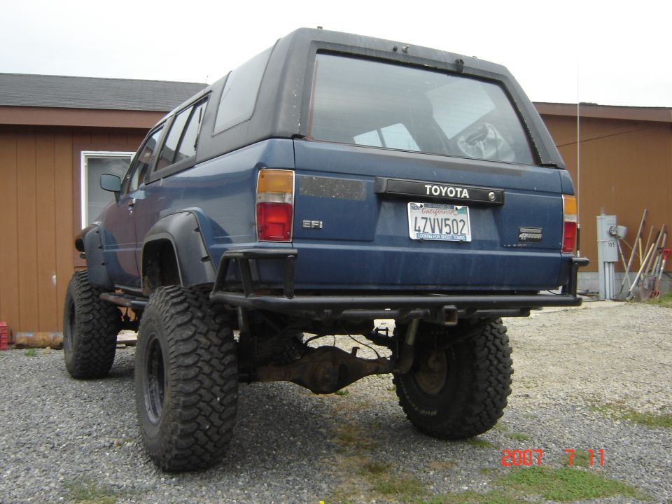 Blue 1993 Toyota 4Runner rear view with off-road tires and bumper