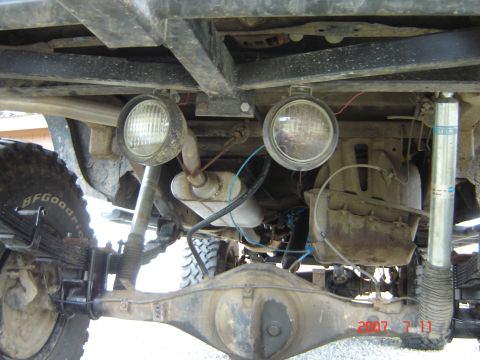 1993 Ford Bronco - Undercarriage of a modified off-road vehicle with auxiliary lights and BFGoodrich tires.