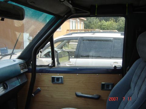 1993 Ford Bronco - View from inside a vehicle, looking out at another SUV parked nearby.