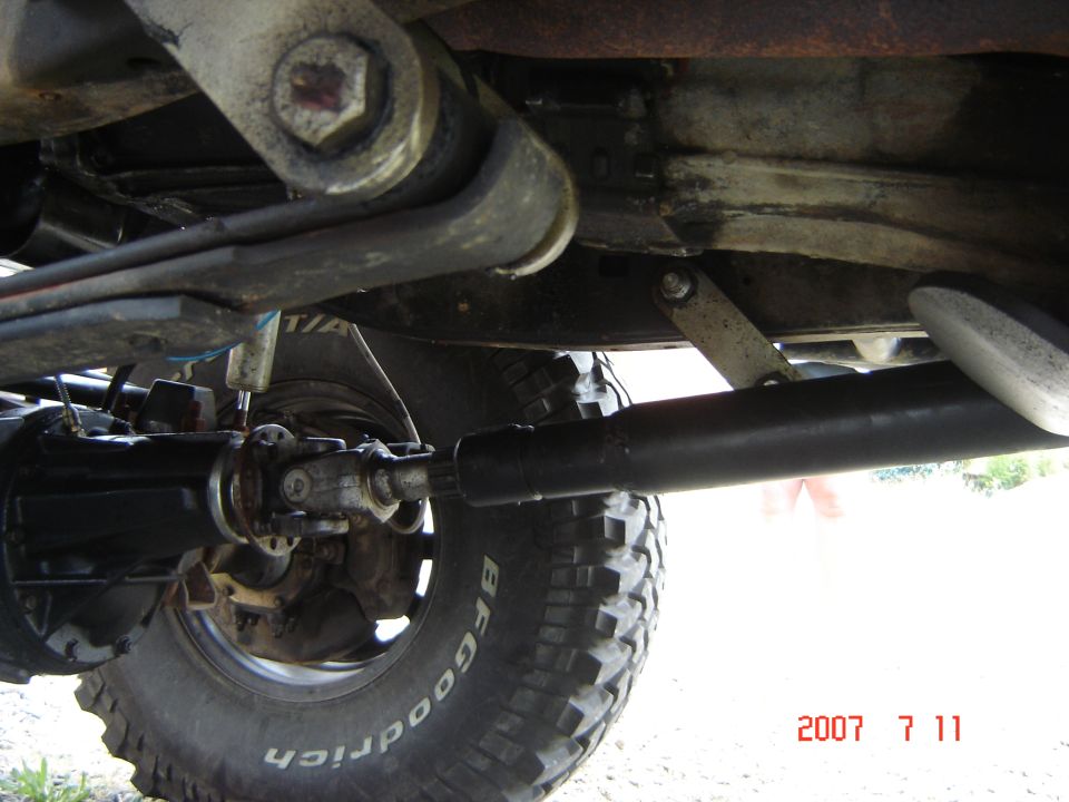 Underside view of a 4x4's suspension and drive shaft with BFGoodrich tires