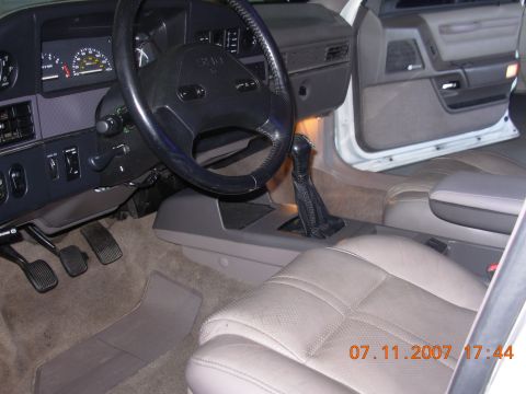 1995 Ford Taurus - Interior view of a 1995 Ford Taurus, the dashboard, steering wheel, and seats.