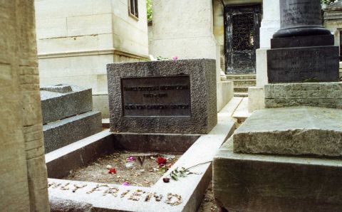 1992 Ford Bronco - A tombstone with flowers and inscriptions in a cemetery. The text mentions 'Jim Morrison 1943-1971'.