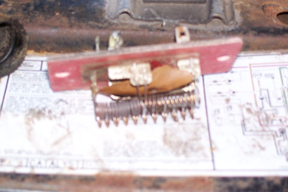 Close-up of a blower motor resistor with visible corrosion on the coils