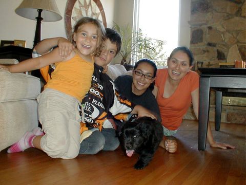 1996 Ford Bronco - A family and their puppy are captured in a candid moment indoors.