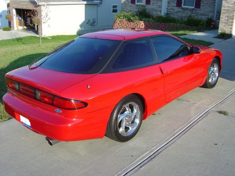 1997 Ford Probe - This red 1997 Ford Probe is captured from a rear three-quarter angle, its sporty coupe design.