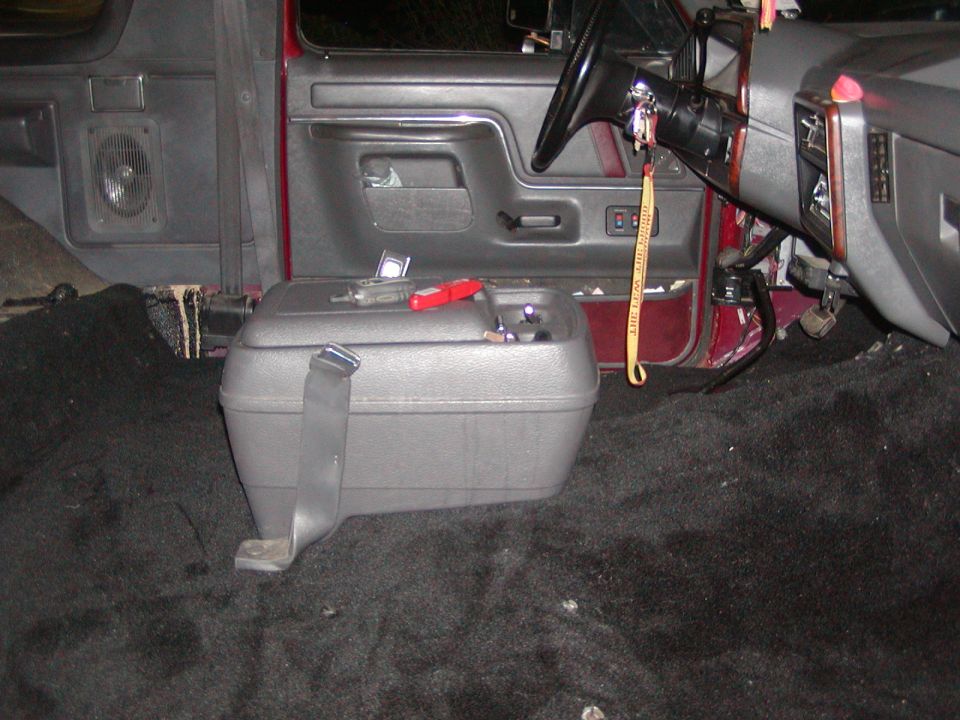 1991 Ford Bronco interior showing removed carpet and center console