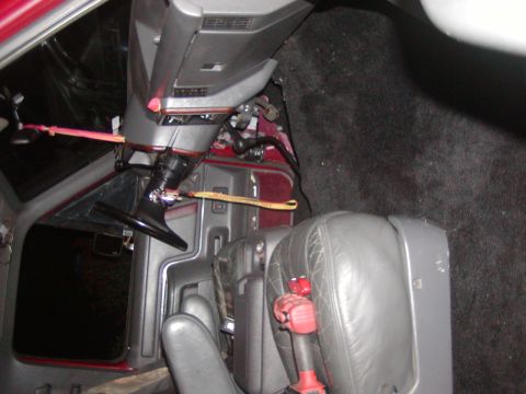 1991 Ford Bronco - Interior view of a 1991 Ford Bronco, highlighting the steering column, seats, and floor carpet.