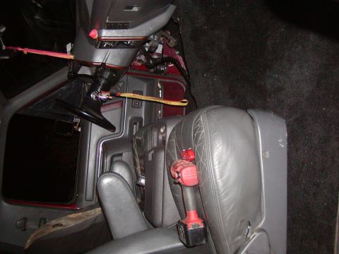 1991 Ford Bronco - Drill placed on the passenger seat inside a vehicle's interior.