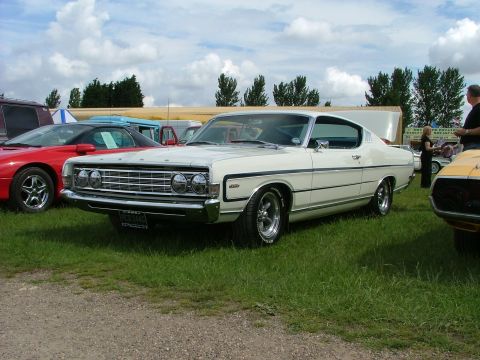 2001 Ford Fiesta - A white 1968 Ford Torino GT is parked on grass with other vehicles nearby.